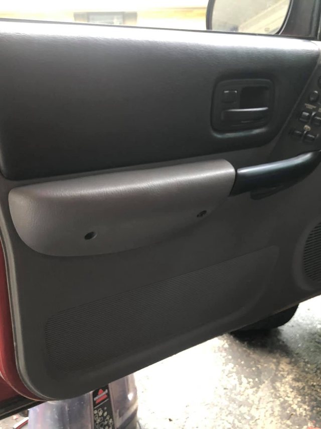 The same door panel after the interior detail — the trim is clean and evenly dressed.